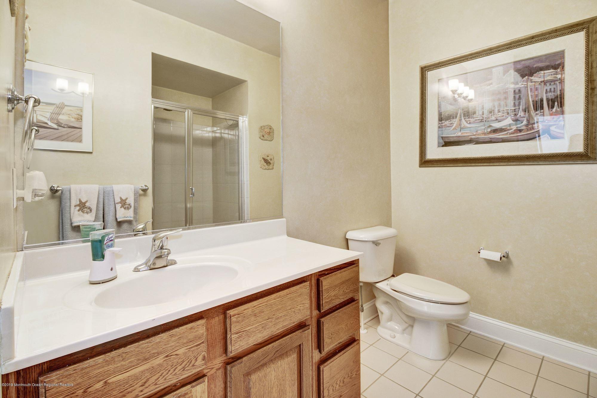 1006 Abby Road Middletown, NJ 07748 - Photo 31 of 44 a bathroom with a sink mirror vanity and toilet