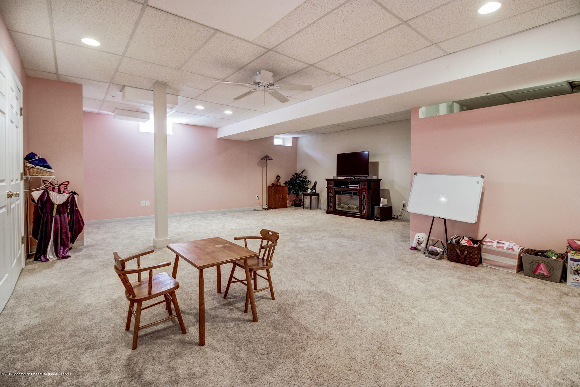 1006 Abby Road Middletown, NJ 07748 - Photo 37 of 44 a view of a room with furniture and a flat screen tv