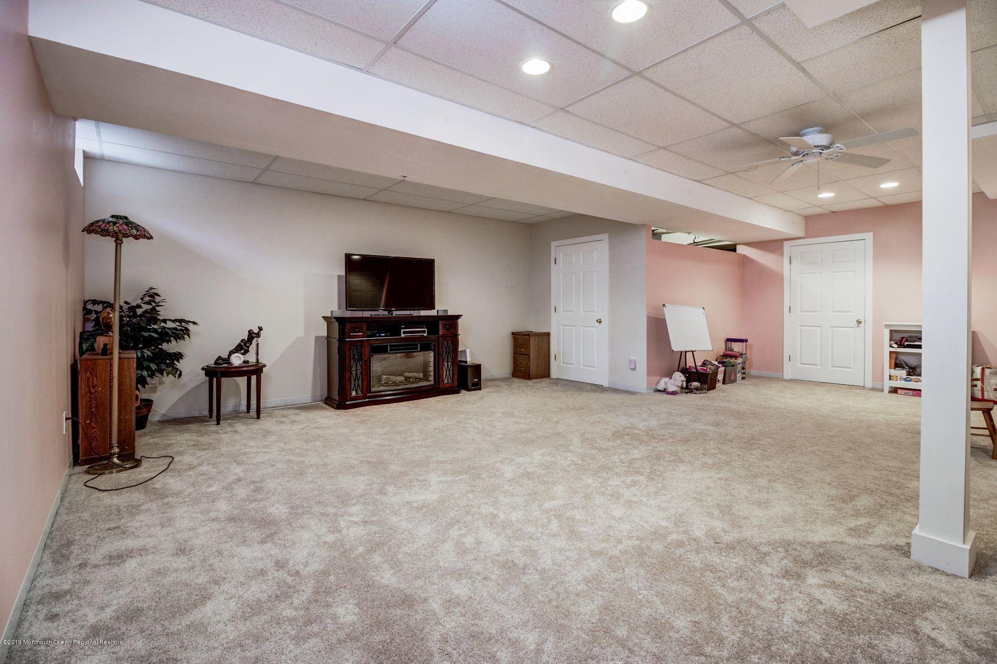 1006 Abby Road Middletown, NJ 07748 - Photo 38 of 44 a living room with furniture and a flat screen tv