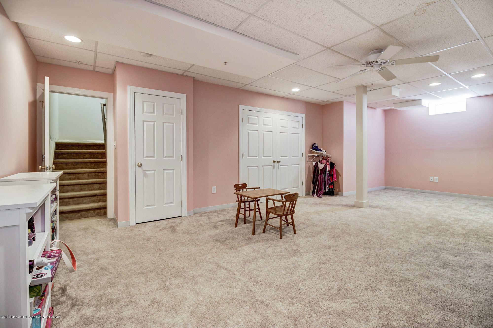 1006 Abby Road Middletown, NJ 07748 - Photo 40 of 44 an empty room with furniture and a chandelier fan