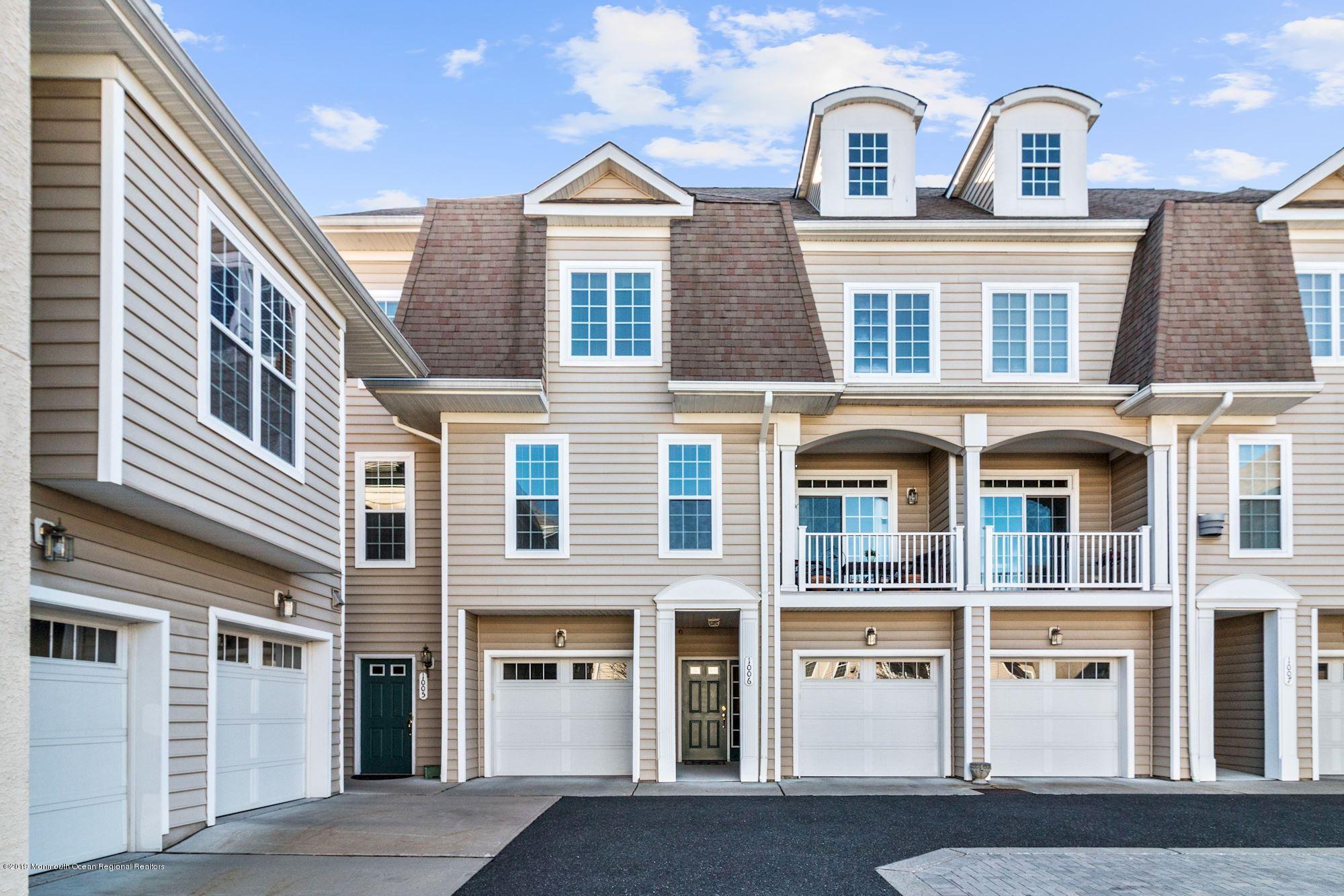 1006 Abby Road Middletown, NJ 07748 - Photo 4 of 44 a front view of a residential apartment building with a yard