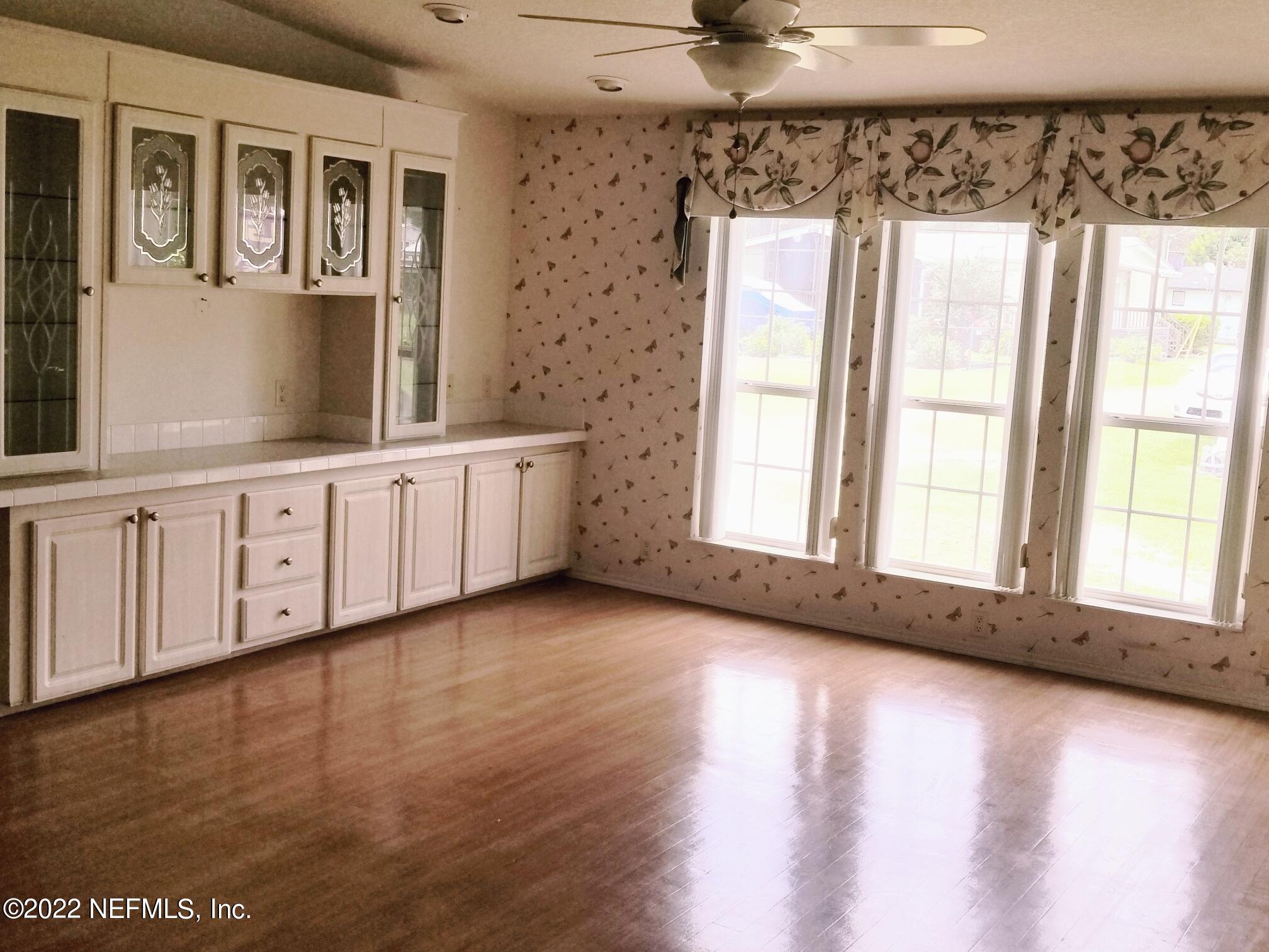 121 Jimmie Road Crescent City, FL 32112 - Photo 18 of 45 a view of an empty room with a window and wooden floor