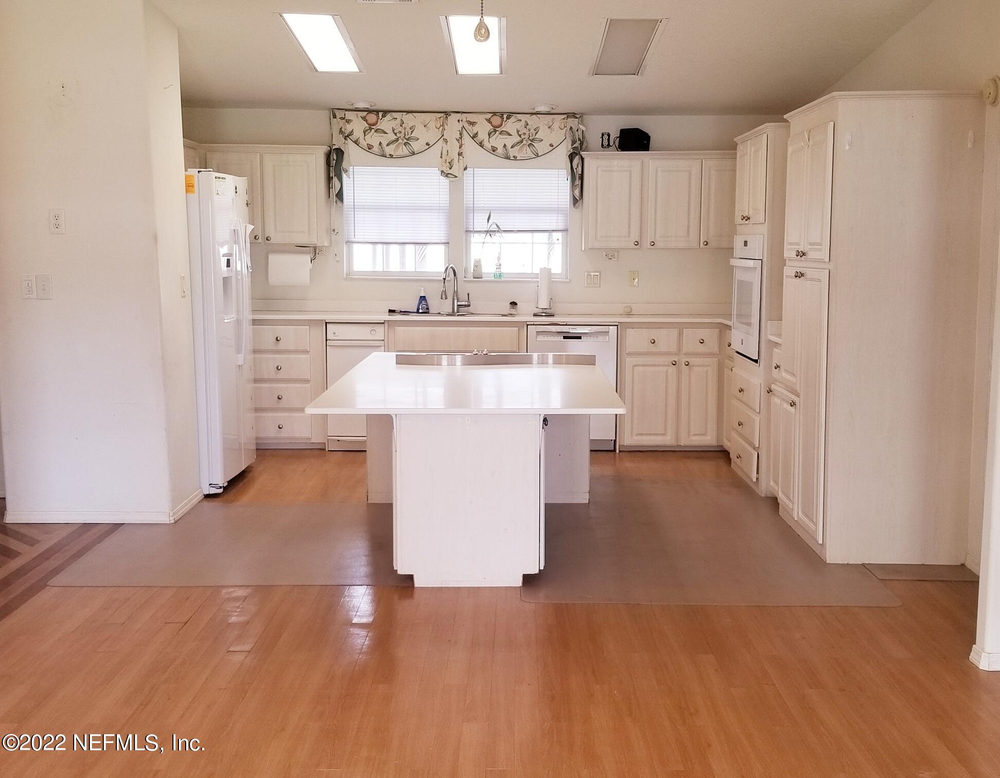 121 Jimmie Road Crescent City, FL 32112 - Photo 19 of 45 a kitchen with white cabinets and window