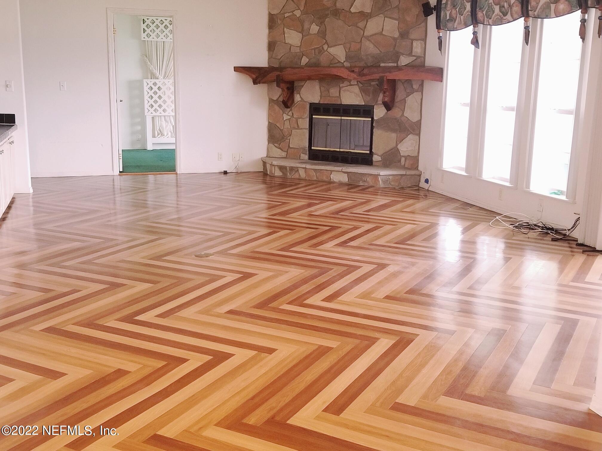 121 Jimmie Road Crescent City, FL 32112 - Photo 20 of 45 a view of empty room with wooden floor and fireplace