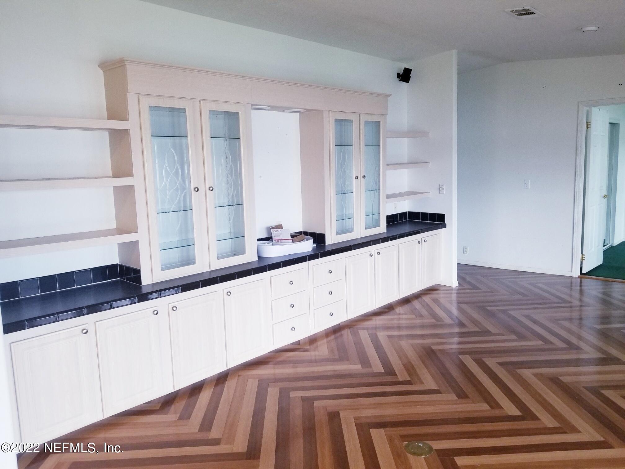 121 Jimmie Road Crescent City, FL 32112 - Photo 22 of 45 a kitchen with granite countertop white cabinets and white appliances