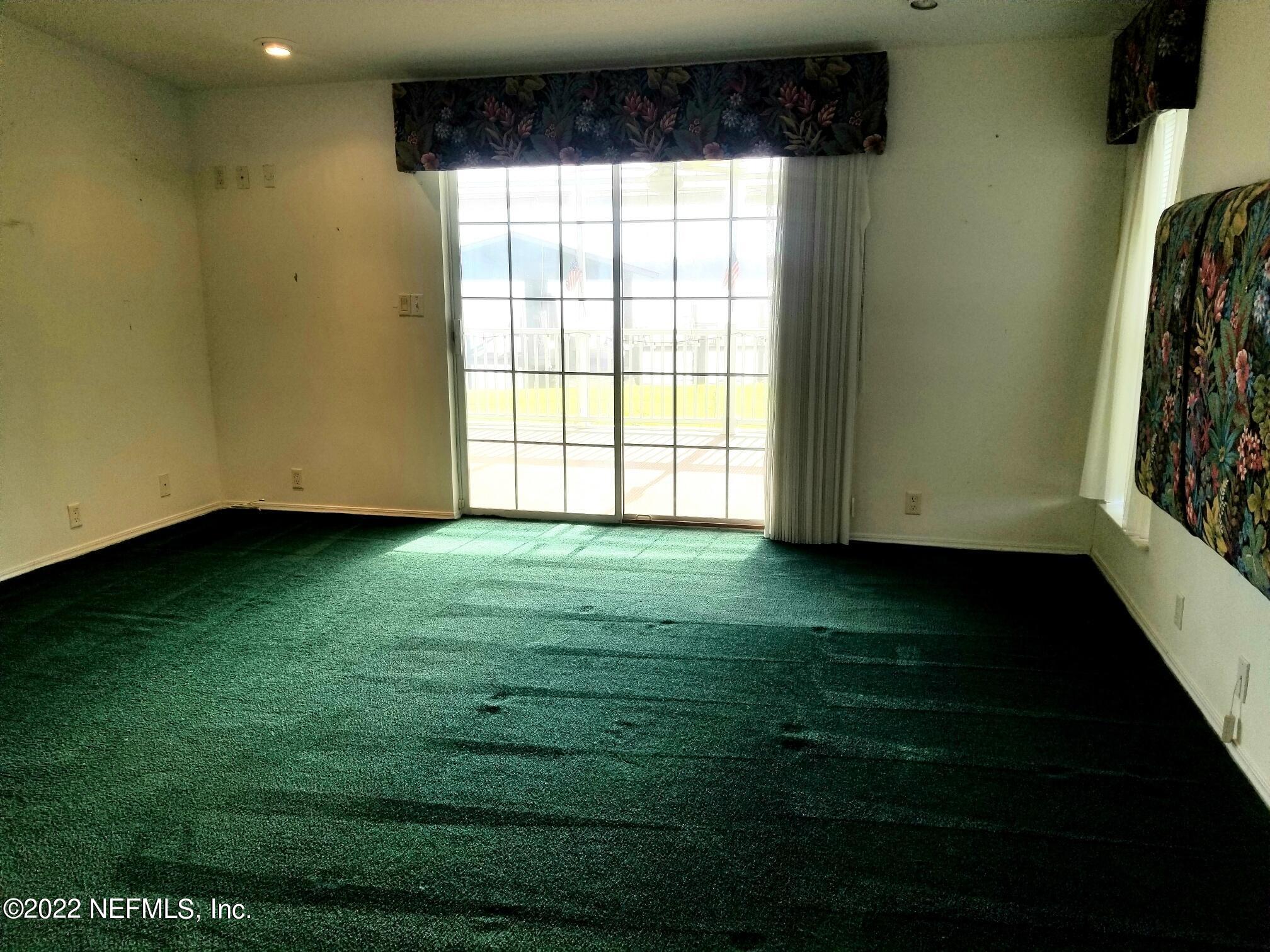 121 Jimmie Road Crescent City, FL 32112 - Photo 26 of 45 a view of an empty room with wooden floor and a window