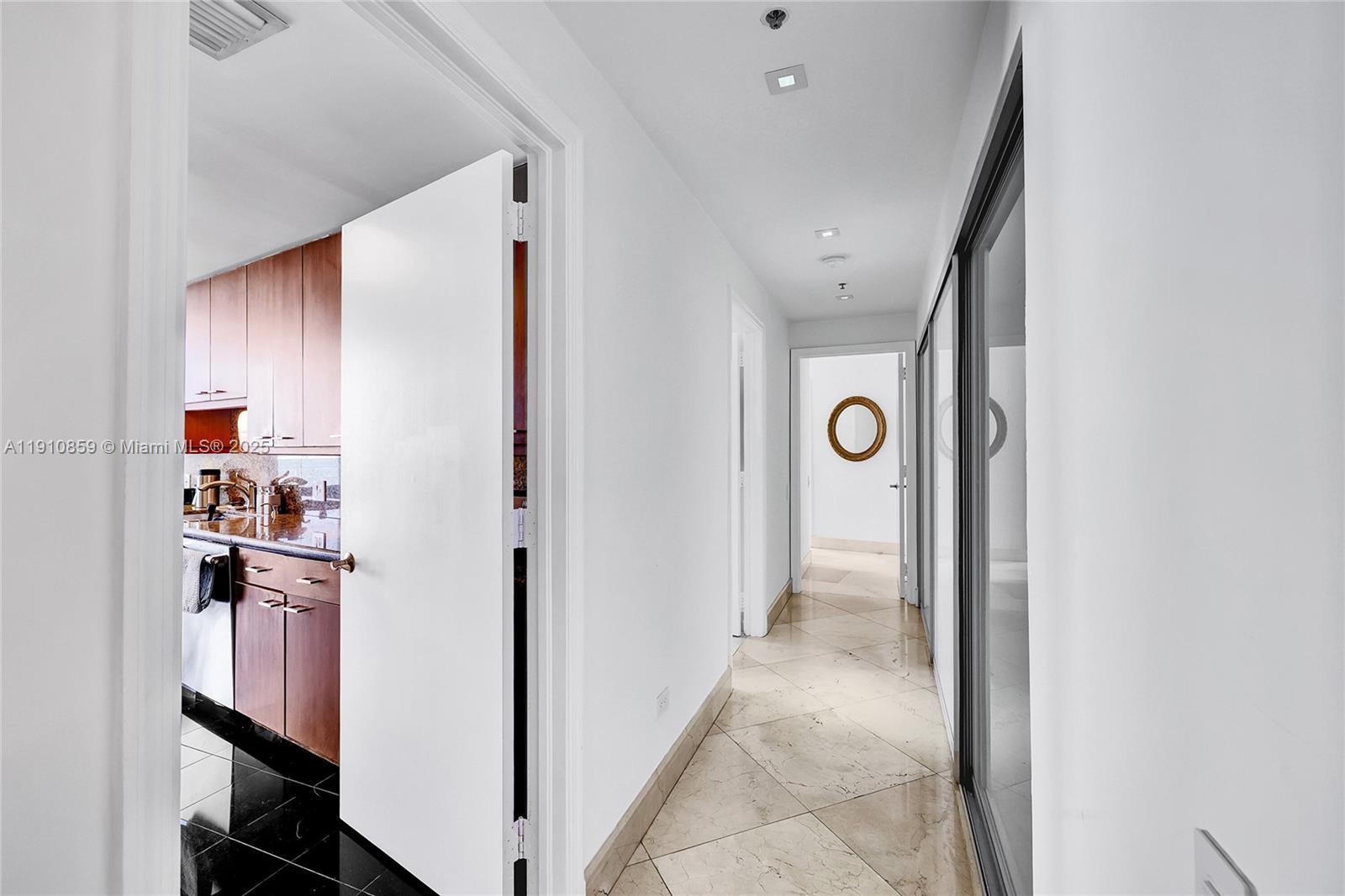 808 Brickell Key Drive, Unit 2104 Miami, FL 33131 - Photo 7 of 29 a view of a hallway with closet and a bathroom