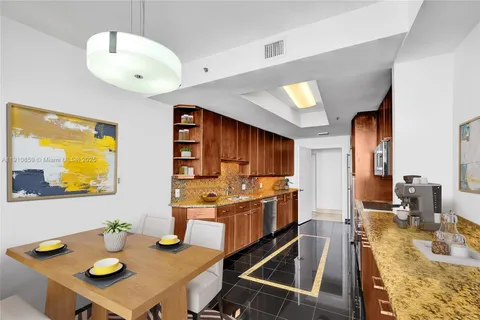 a kitchen with stainless steel appliances granite countertop a sink and cabinets