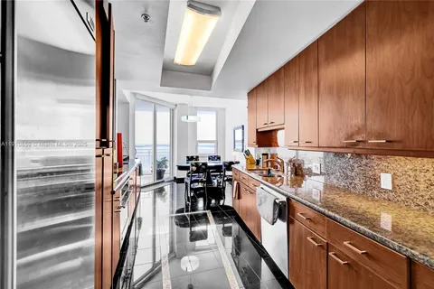 a kitchen with granite countertop lots of counter top space a sink and cabinets