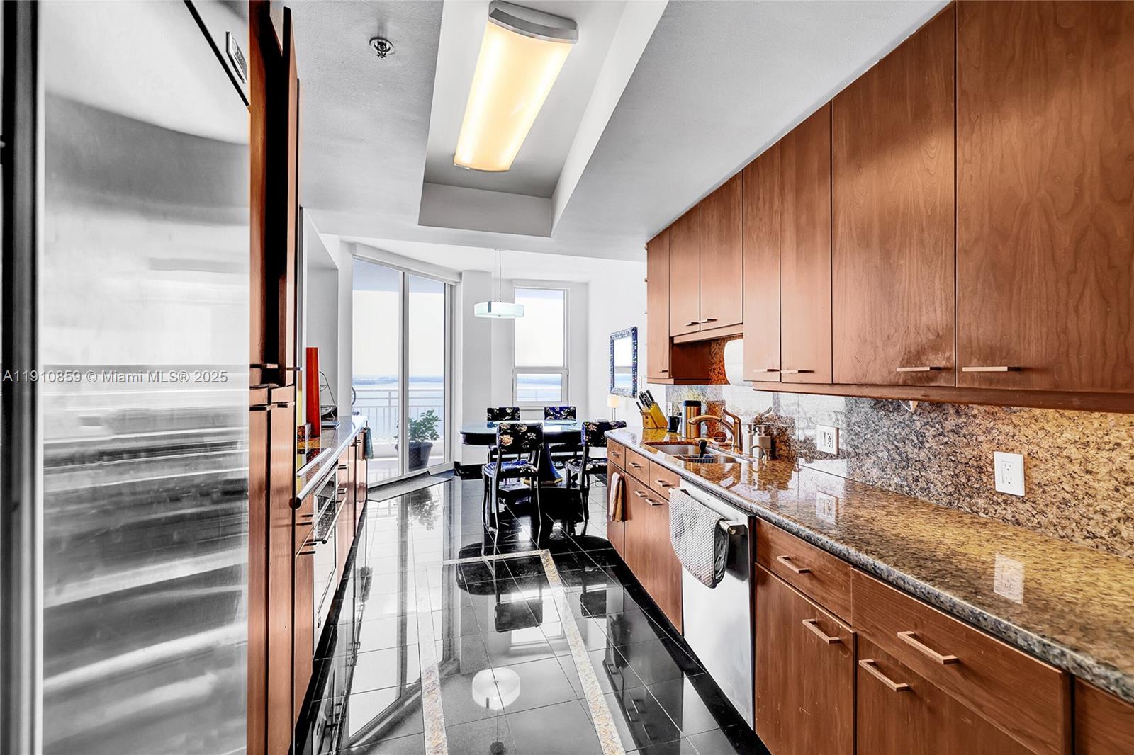 808 Brickell Key Drive, Unit 2104 Miami, FL 33131 - Photo 10 of 29 a kitchen with granite countertop lots of counter top space a sink and cabinets