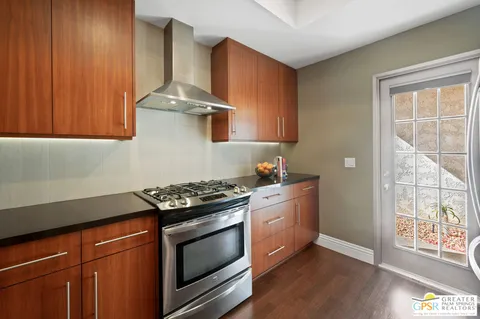 a kitchen with granite countertop stainless steel appliances and wooden cabinets