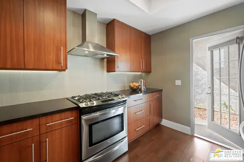 a kitchen with stainless steel appliances a stove a sink and a cabinets