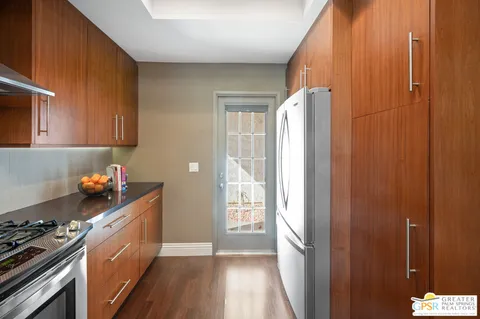 a kitchen with a refrigerator a stove a sink and cabinets