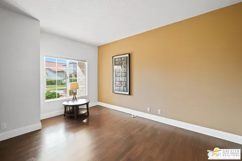 a living room with a wooden floor and a window