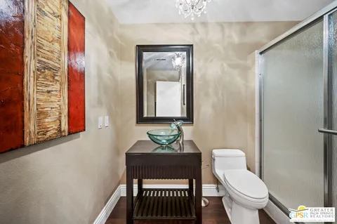 a bathroom with a toilet a sink and a mirror