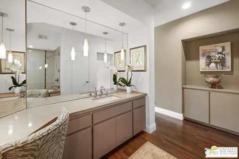 a spacious bathroom with a double vanity sink and a mirror