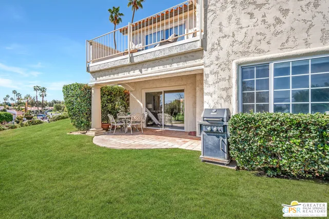 a view of a house with backyard porch and sitting area