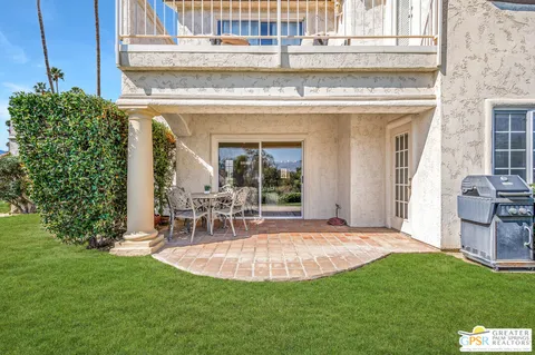 a view of a house with a backyard porch and sitting area
