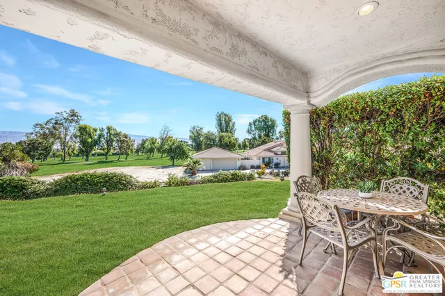 a view of a patio with a yard