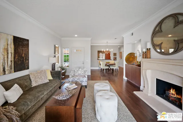 a living room with furniture a fireplace a rug and a window