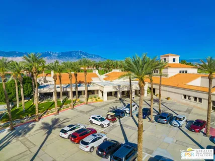 a view of multiple houses with swimming pool