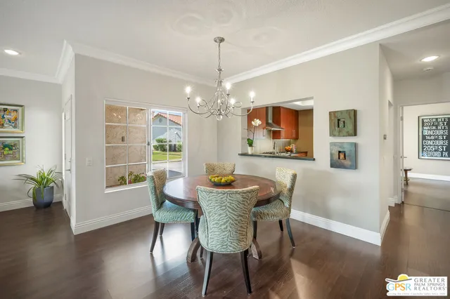 a dining room with furniture potted plants and wooden floor