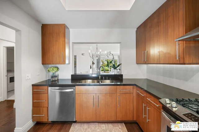 a kitchen with stainless steel appliances granite countertop a sink and a cabinets