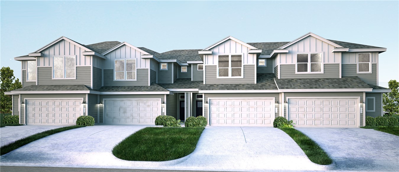 a front view of a house with a garden and garage