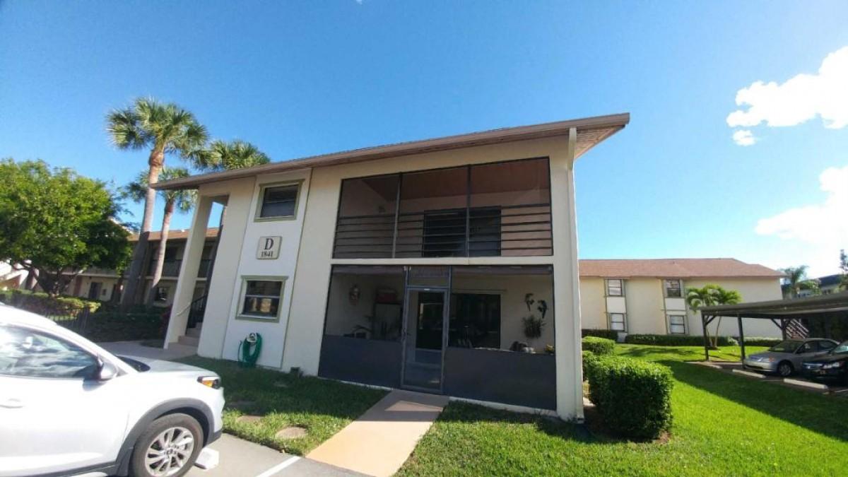 1841 Southwest Palm City Road, Unit D102 Stuart, FL 34994 - Photo 1 of 17 a front view of a house with a yard