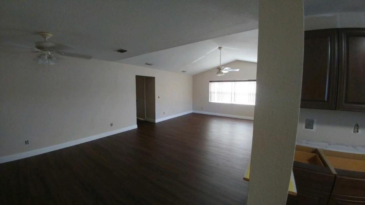 1841 Southwest Palm City Road, Unit D102 Stuart, FL 34994 - Photo 13 of 17 an empty room with wooden floor and windows