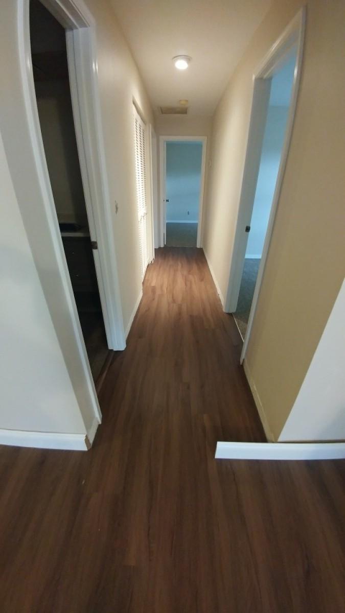 1841 Southwest Palm City Road, Unit D102 Stuart, FL 34994 - Photo 10 of 17 wooden floor in an empty room with wooden floor