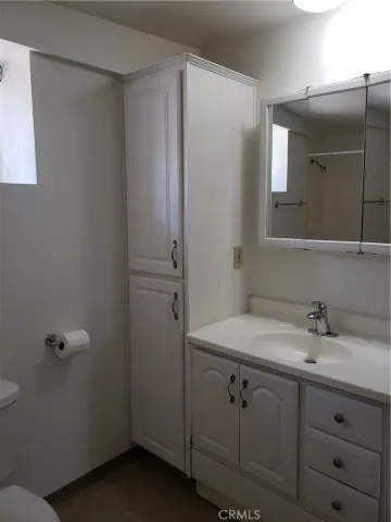 a bathroom with a sink vanity and mirror
