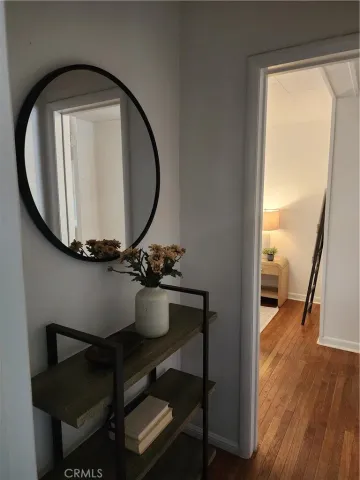 a view of a room that has a mirror and a wooden floor