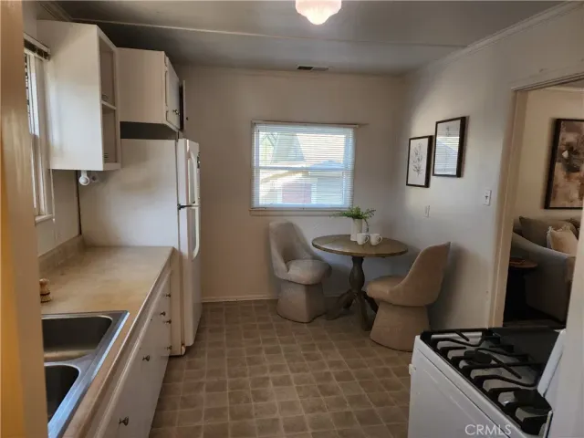 a kitchen with a sink stove and refrigerator