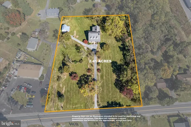 a front view of a house with yard swimming pool and outdoor seating