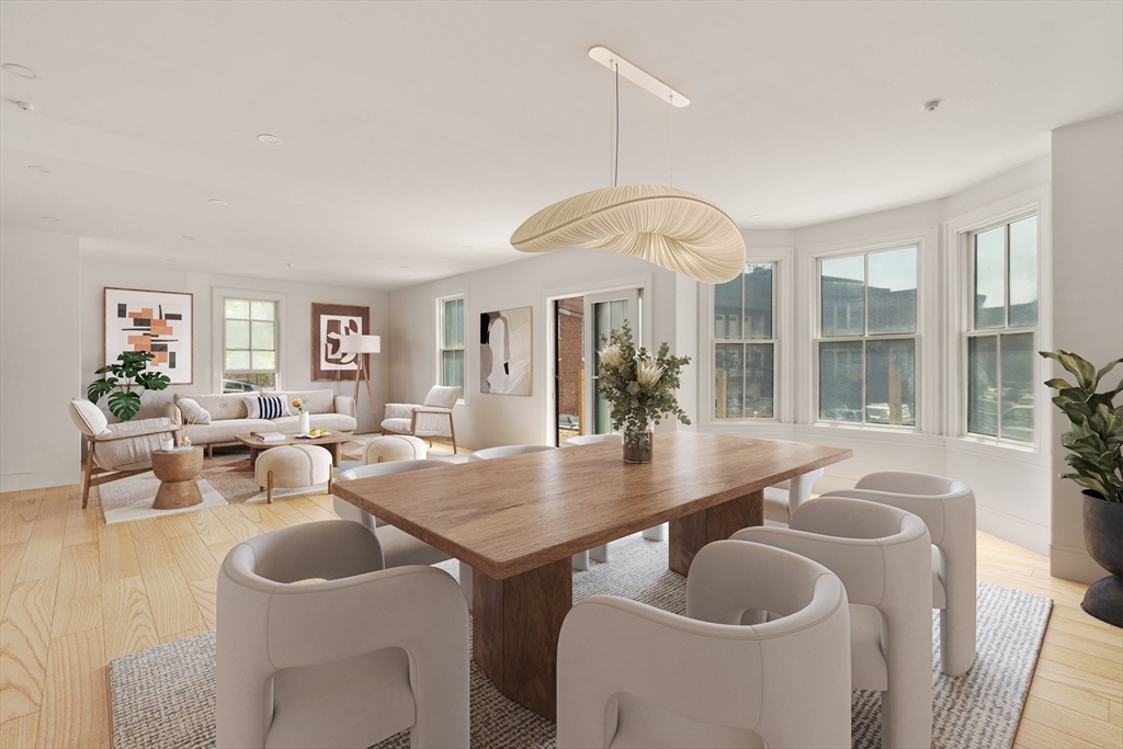 12 Goodwin Place, Unit 122 Brookline, MA 02445 - Photo 2 of 6 a dining room with furniture a chandelier and window
