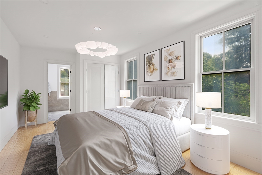 12 Goodwin Place, Unit 122 Brookline, MA 02445 - Photo 3 of 6 a bedroom with a bed and a large window