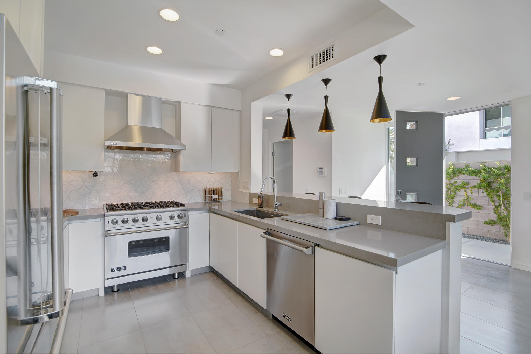 305 Goleta Way Palm Springs, CA 92264 - Photo 11 of 34 a kitchen with stainless steel appliances granite countertop a sink stove and refrigerator