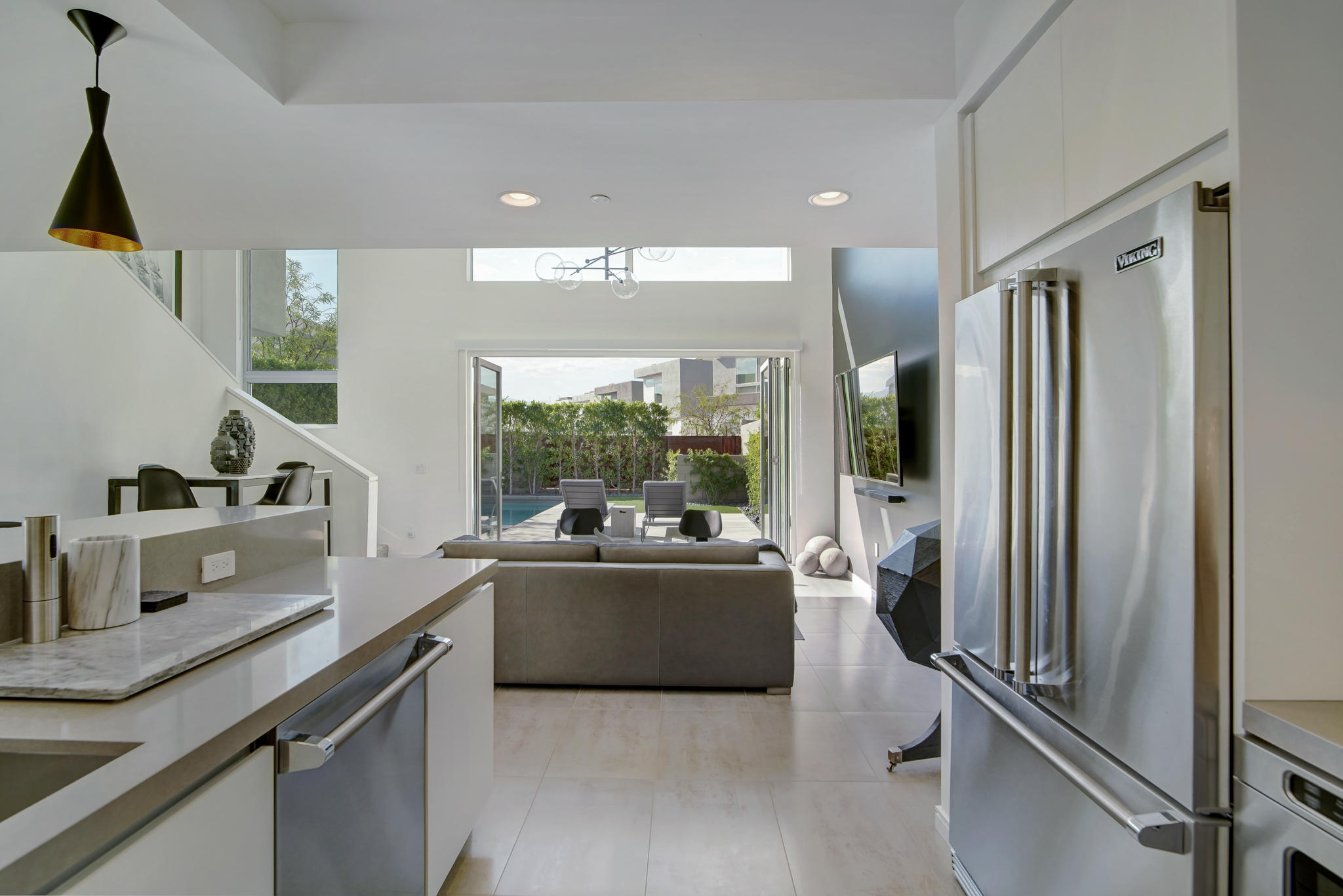 305 Goleta Way Palm Springs, CA 92264 - Photo 12 of 34 a living room with stainless steel appliances kitchen island granite countertop a sink and a refrigerator