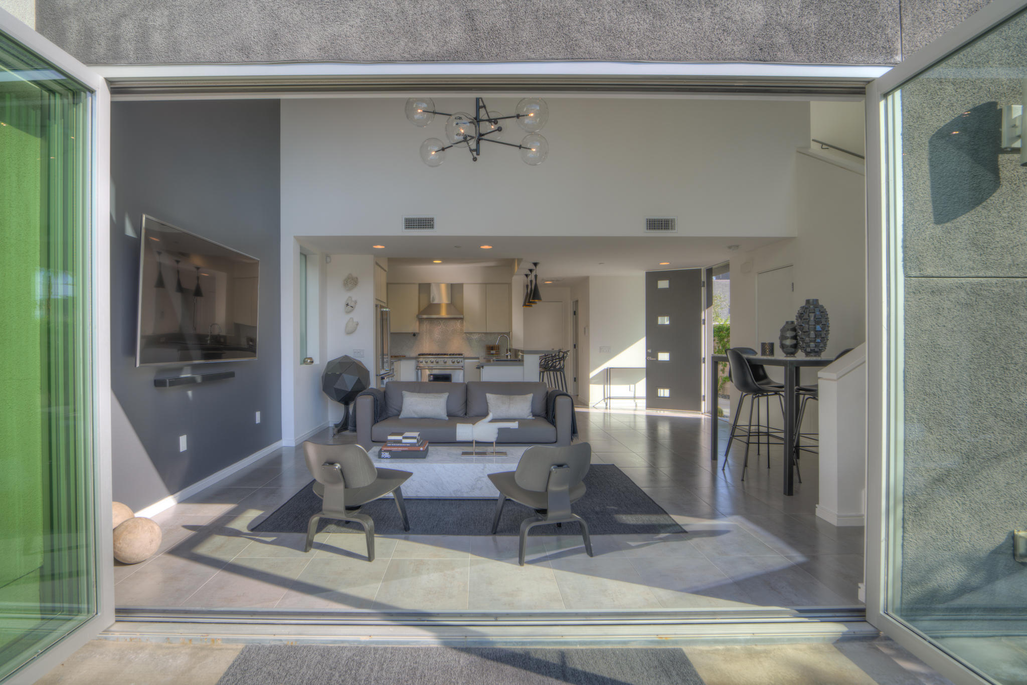305 Goleta Way Palm Springs, CA 92264 - Photo 17 of 34 a living room with furniture a large window and stainless steel appliances
