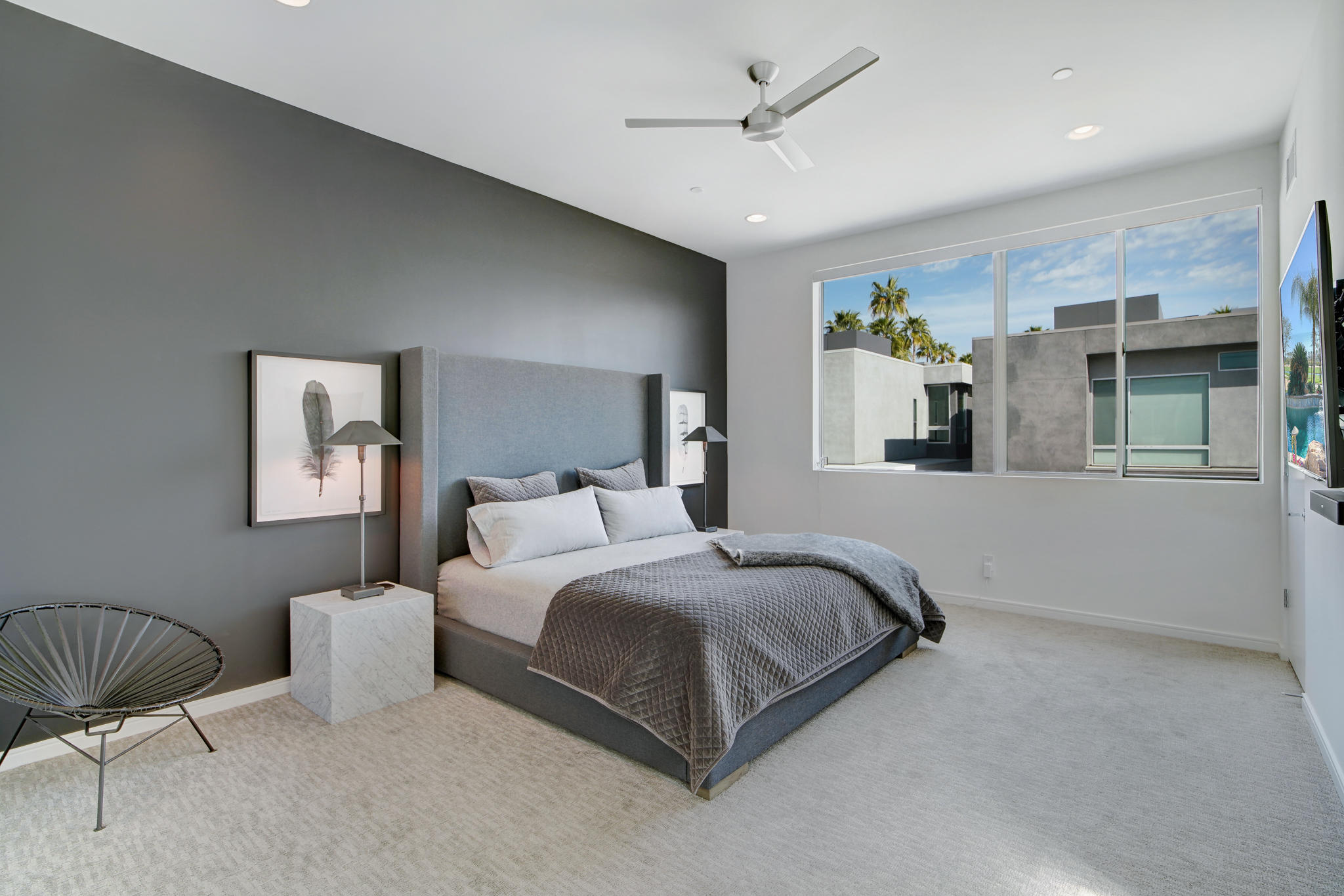 305 Goleta Way Palm Springs, CA 92264 - Photo 18 of 34 a bedroom with a bed and a chair