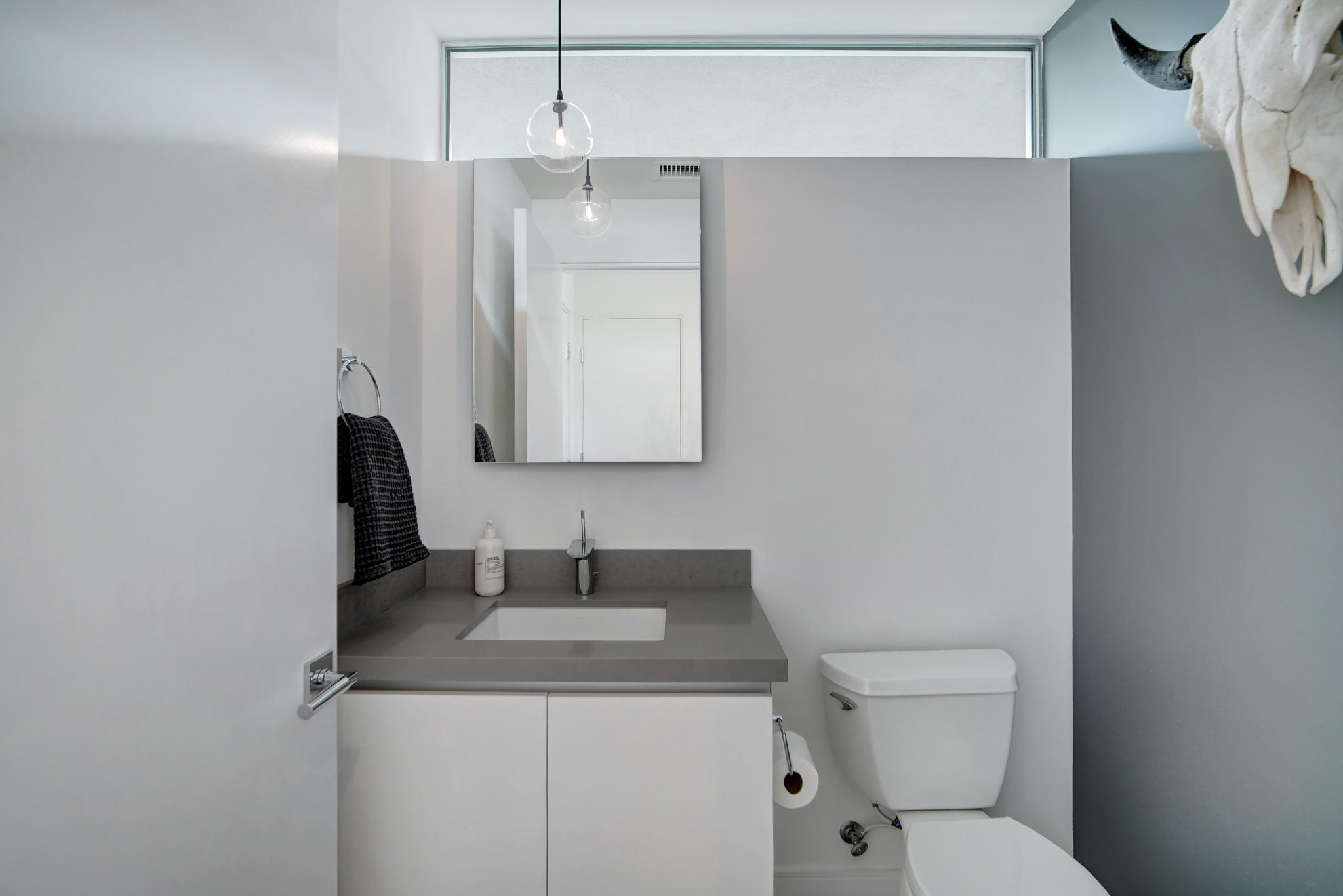 305 Goleta Way Palm Springs, CA 92264 - Photo 25 of 34 a bathroom with a toilet sink vanity and mirror