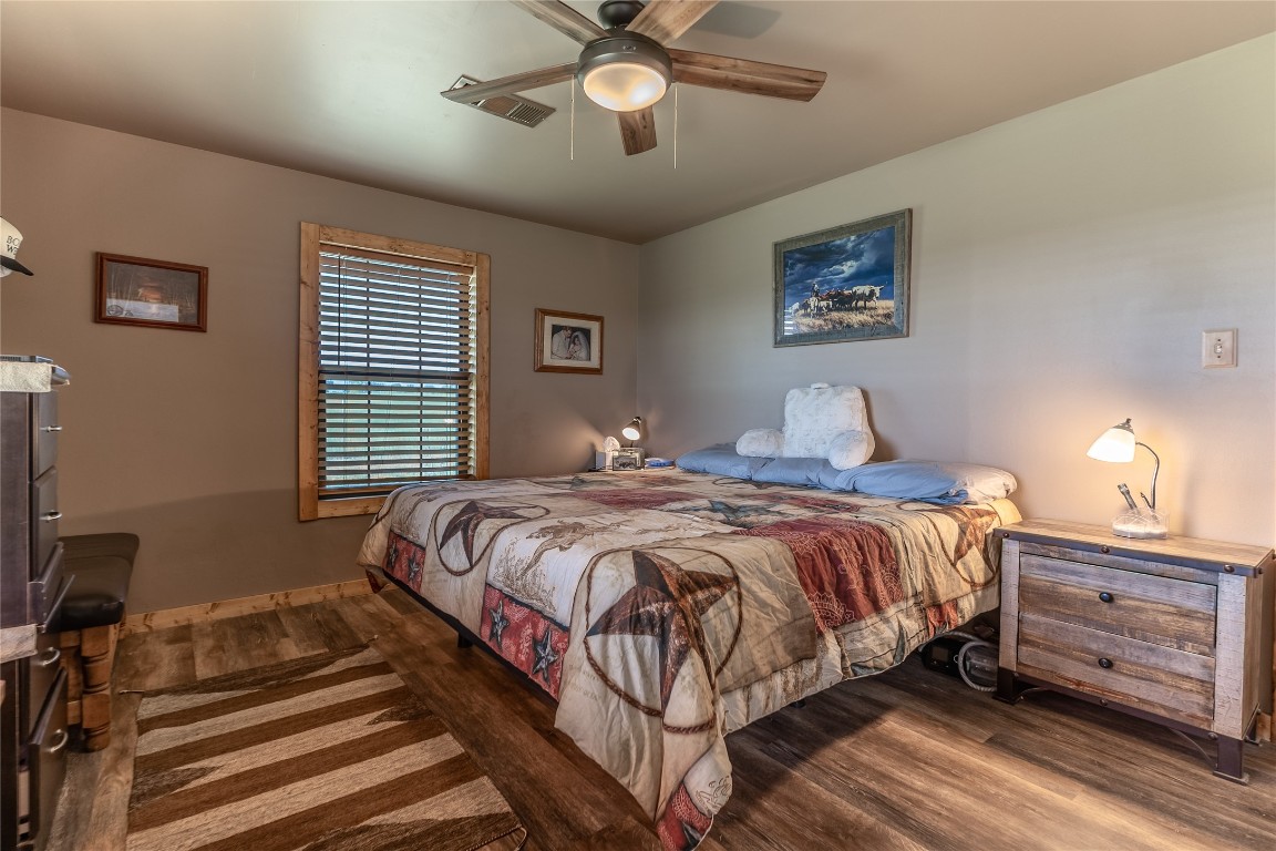 1483 County Road 255 Rochelle, TX 76872 - Photo 12 of 33 a bedroom with a bed and a chandelier