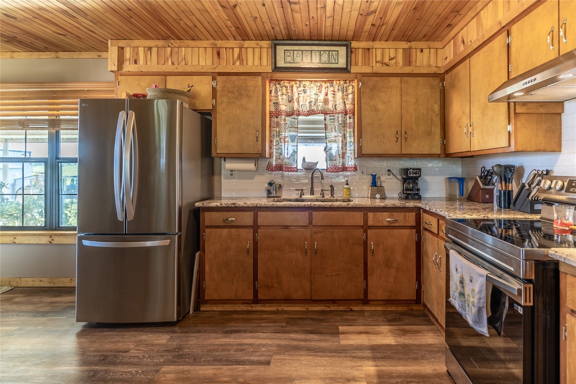1483 County Road 255 Rochelle, TX 76872 - Photo 16 of 33 a kitchen with stainless steel appliances granite countertop a refrigerator a sink a stove and dishwasher with wooden floor