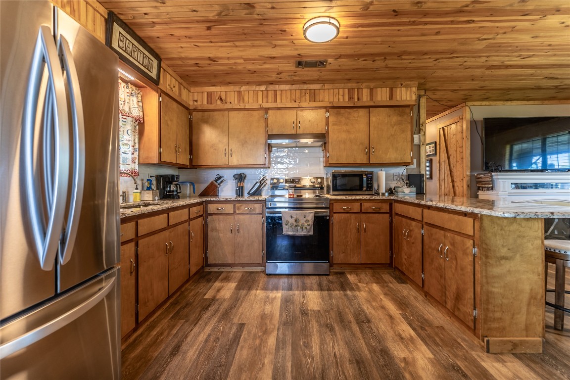 1483 County Road 255 Rochelle, TX 76872 - Photo 6 of 33 a kitchen with stainless steel appliances granite countertop a stove a sink and a refrigerator
