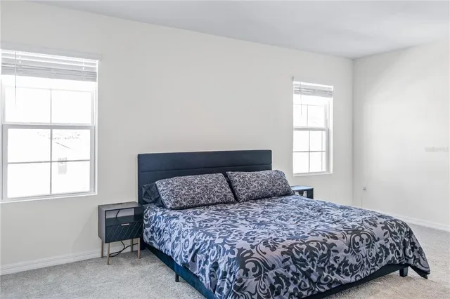 a bedroom with a bed and window