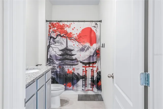 a bathroom with a sink vanity mirror and toilet