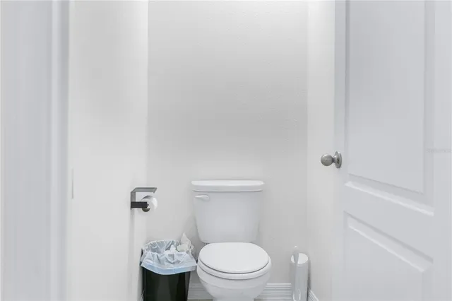 a white toilet sitting next to a bathroom sink