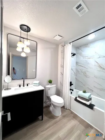 a bathroom with a double vanity sink toilet and shower