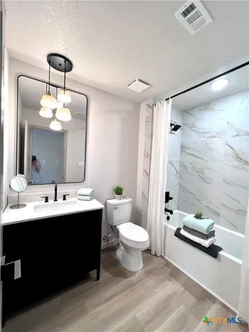 a bathroom with a double vanity sink toilet and shower